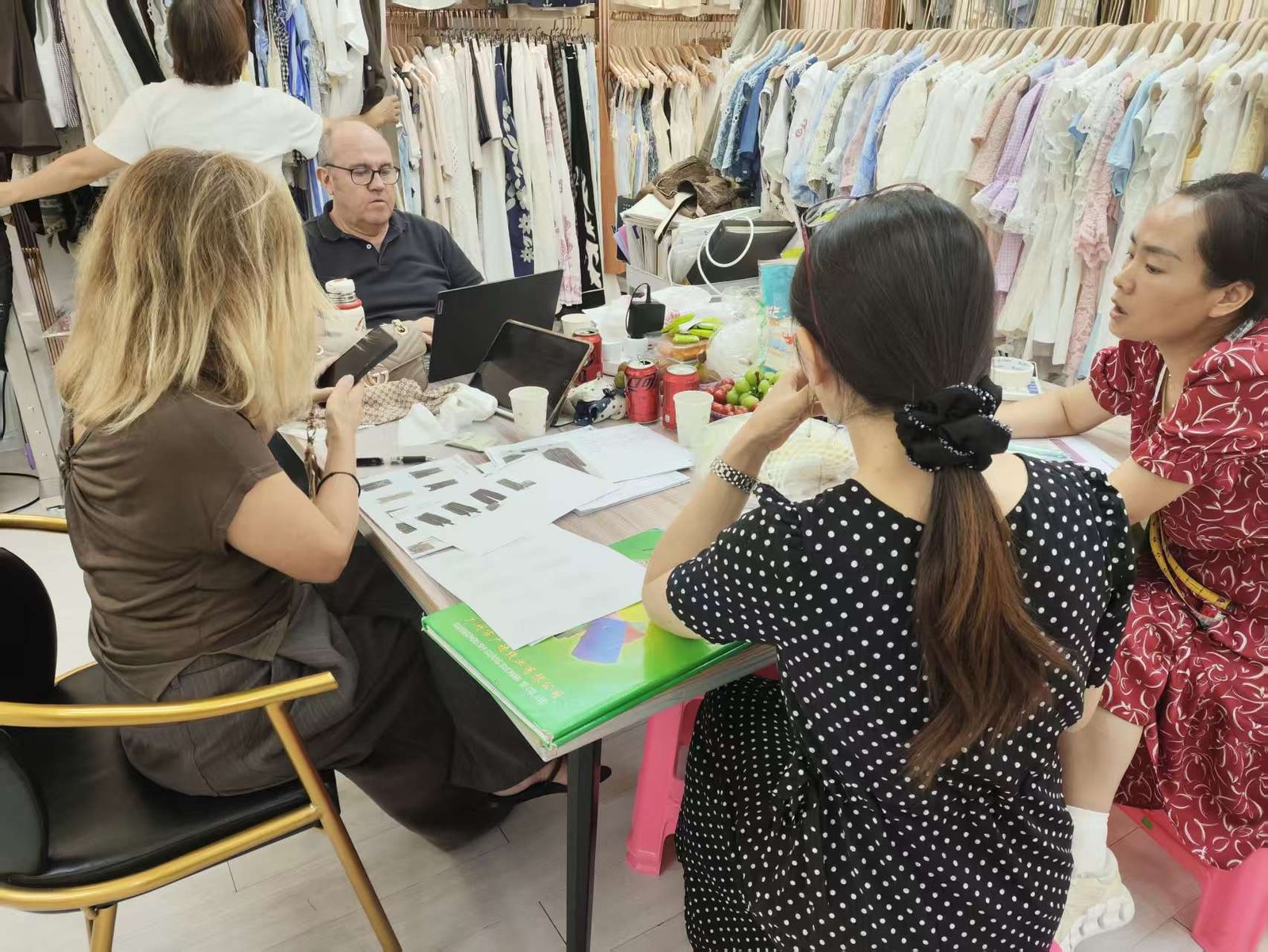 Wholesale buyers selecting womenswear styles at XM Fashion Mfg showroom Xindadi Guangzhou