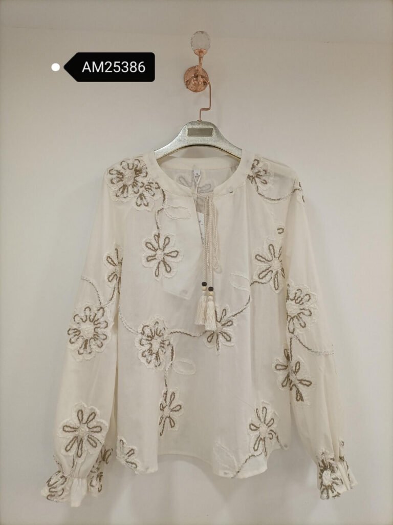 Floral Tassel-Tie Blouse in ivory with taupe floral motifs. Detailed front flat lay view highlighting the overall silhouette. B2B wholesale Blouses & Tops SKU: AM25386.