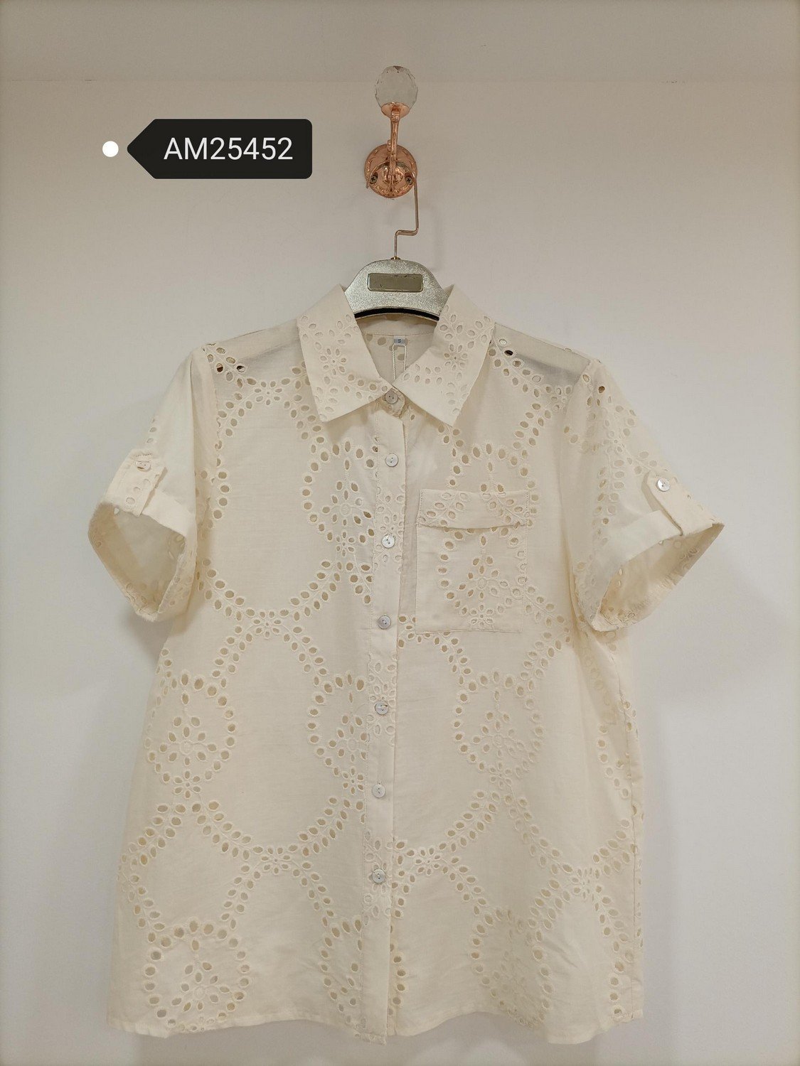 Ivory Perforated Top and Border Shorts in ivory cream. Detailed front flat lay view highlighting the overall silhouette. B2B wholesale Matching Sets SKU: AM25452.