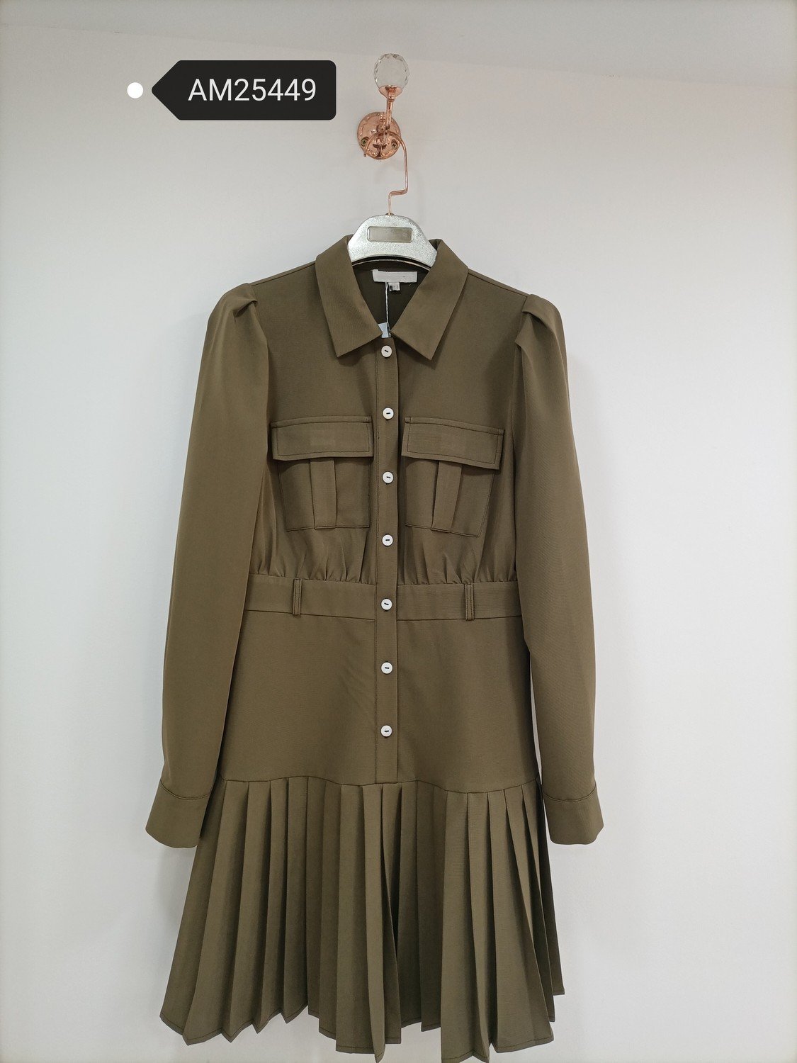 Olive Utility Pleated Shirt Dress in olive brown. Detailed front flat lay view highlighting the overall silhouette. B2B wholesale Dresses SKU: AM25449.
