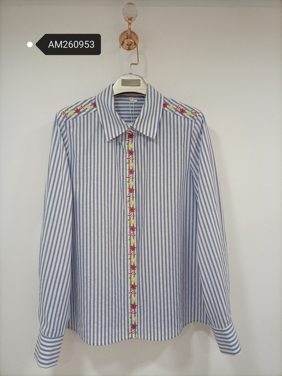 Striped Floral Detail Shirt in light blue and white. Detailed front flat lay view highlighting the overall silhouette. B2B wholesale Blouses & Tops SKU: AM260953.