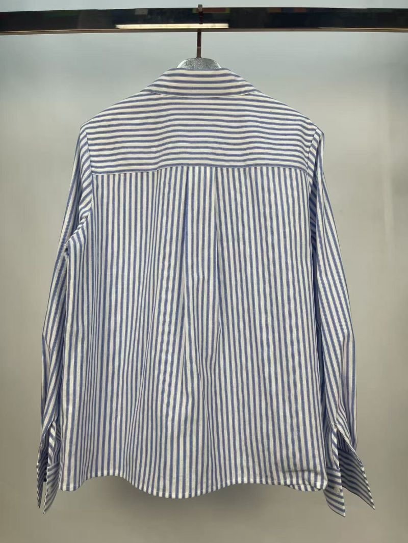 Striped Floral Detail Shirt in light blue and white. Macro close-up view focusing on the Blue-and-white vertical stripes with floral front detailing. B2B wholesale Blouses & Tops SKU: AM260953.