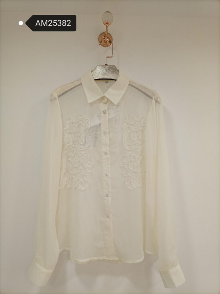 Tonal Scroll Cropped Blouse in ivory white. Detailed front flat lay view highlighting the overall silhouette. B2B wholesale Blouses & Tops SKU: AM25382.