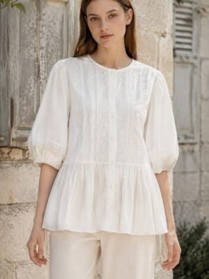 White Openwork Peplum Blouse in white. Lifestyle model shot showcasing the fit and drape. B2B wholesale Blouses & Tops SKU: AM261092.