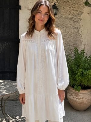 White Openwork Trim Tunic Blouse in white. Lifestyle model shot showcasing the fit and drape. B2B wholesale Blouses & Tops SKU: AM25383.