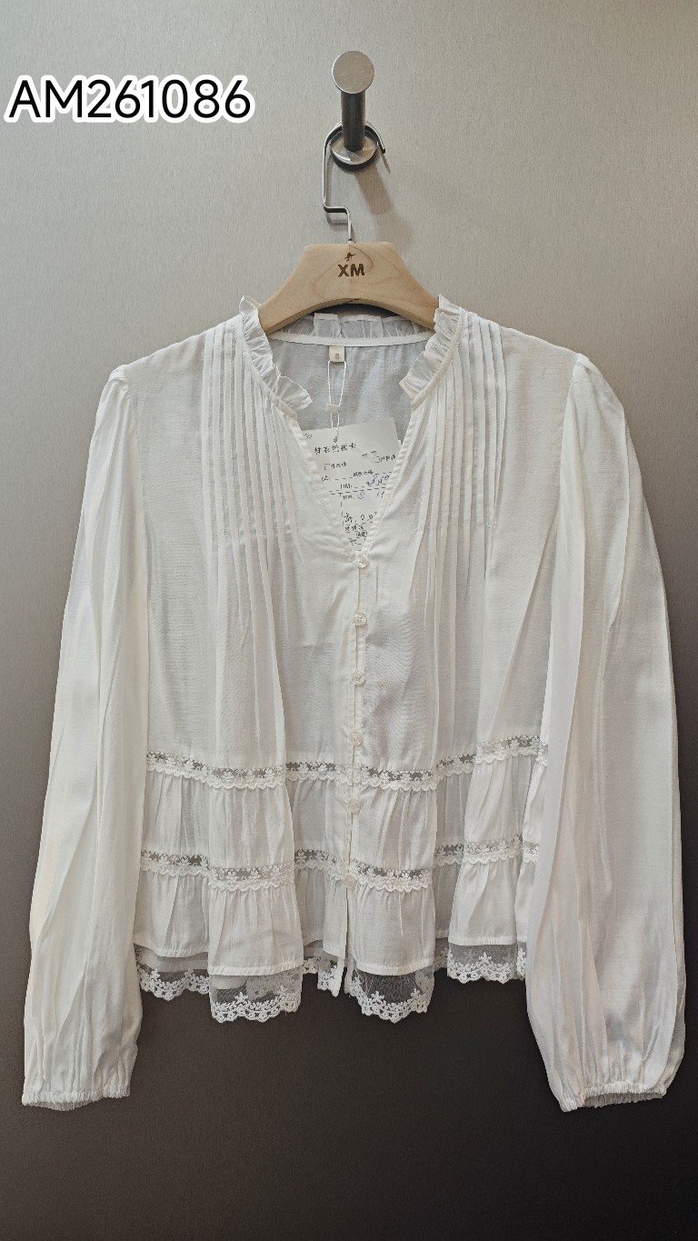 White Tiered Ruffle Collar Blouse in white. Detailed front flat lay view highlighting the overall silhouette. B2B wholesale Blouses & Tops SKU: AM261086.